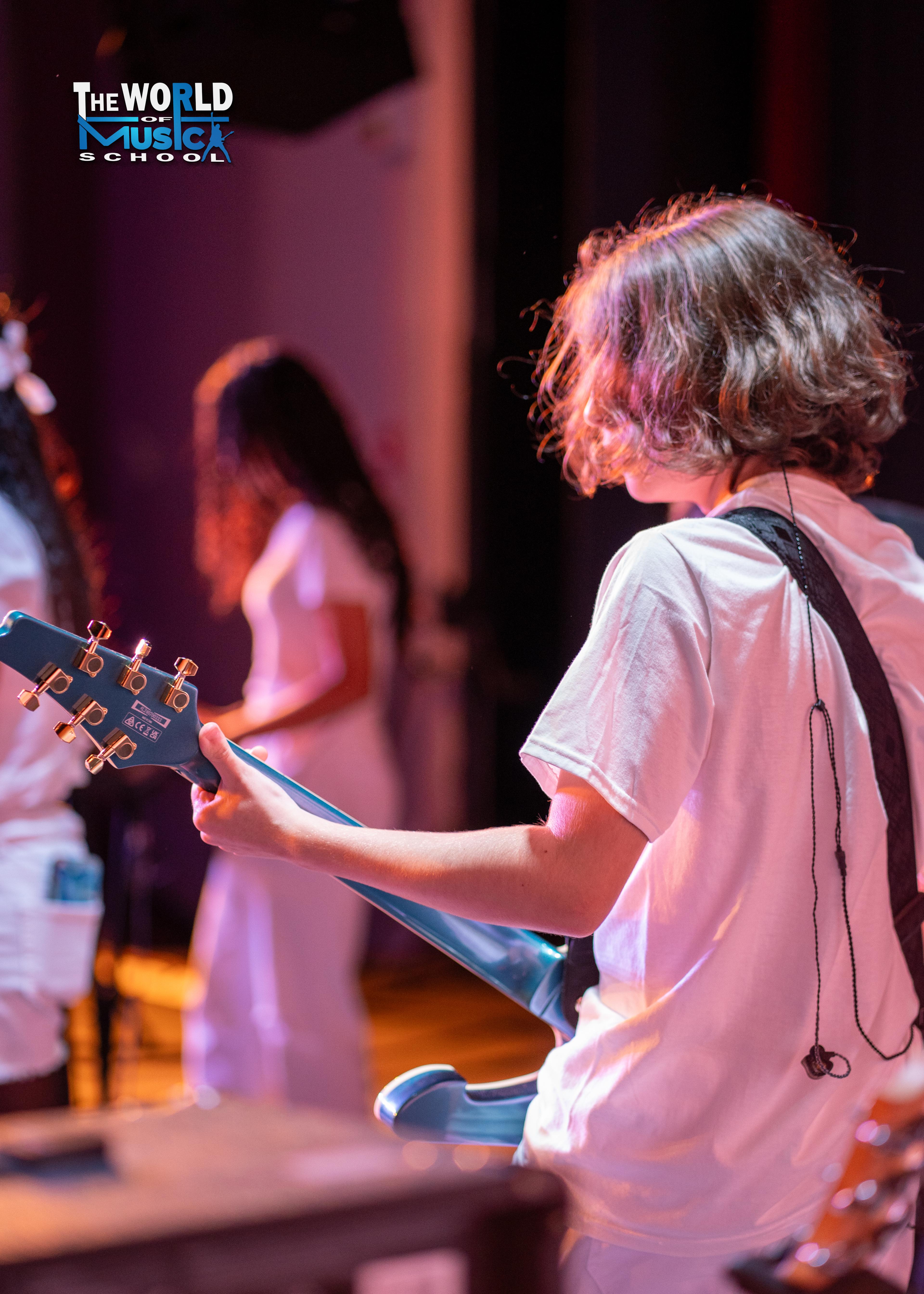 Young guitarist on stage