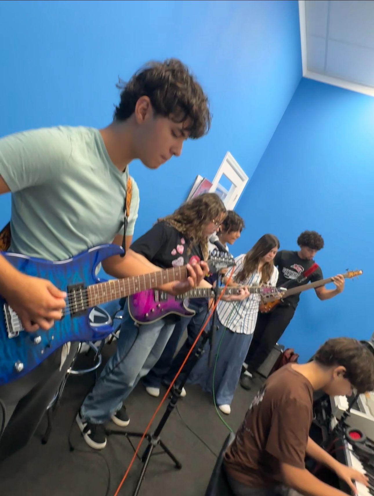 Guitar students rehearsing together in the classroom