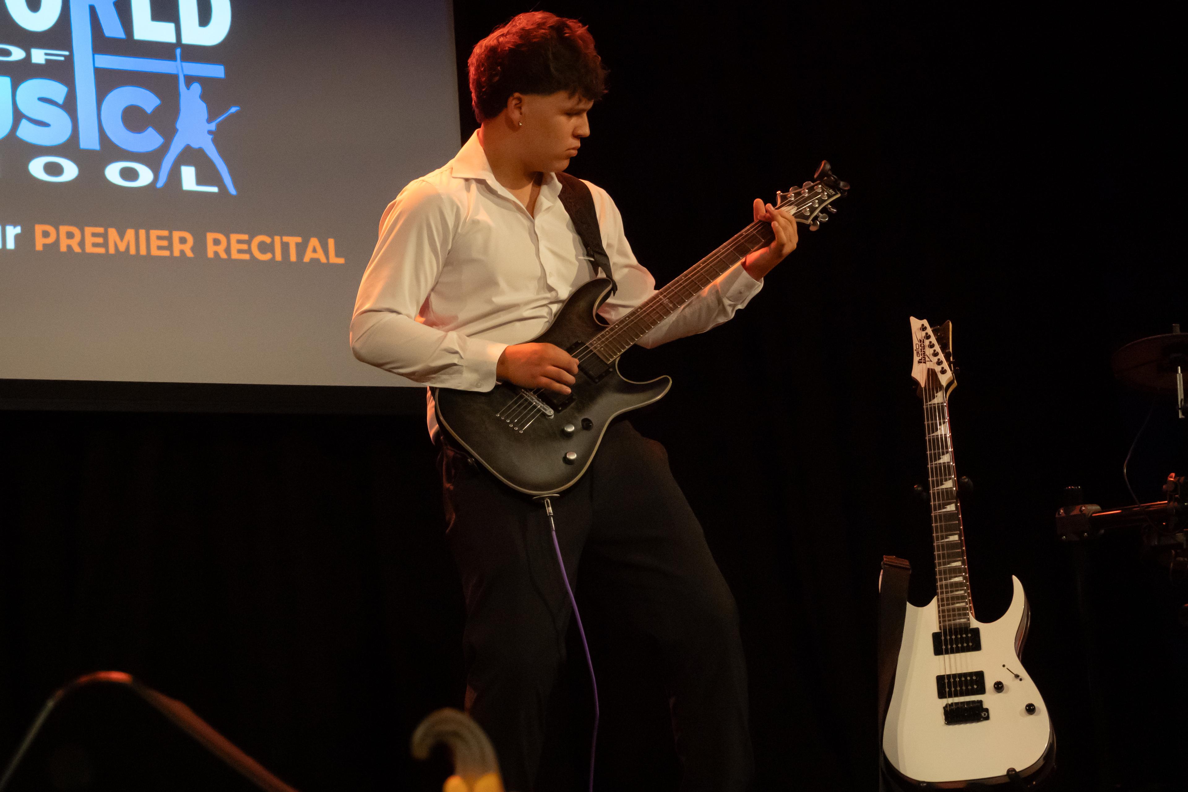 Guitarist performing at recital