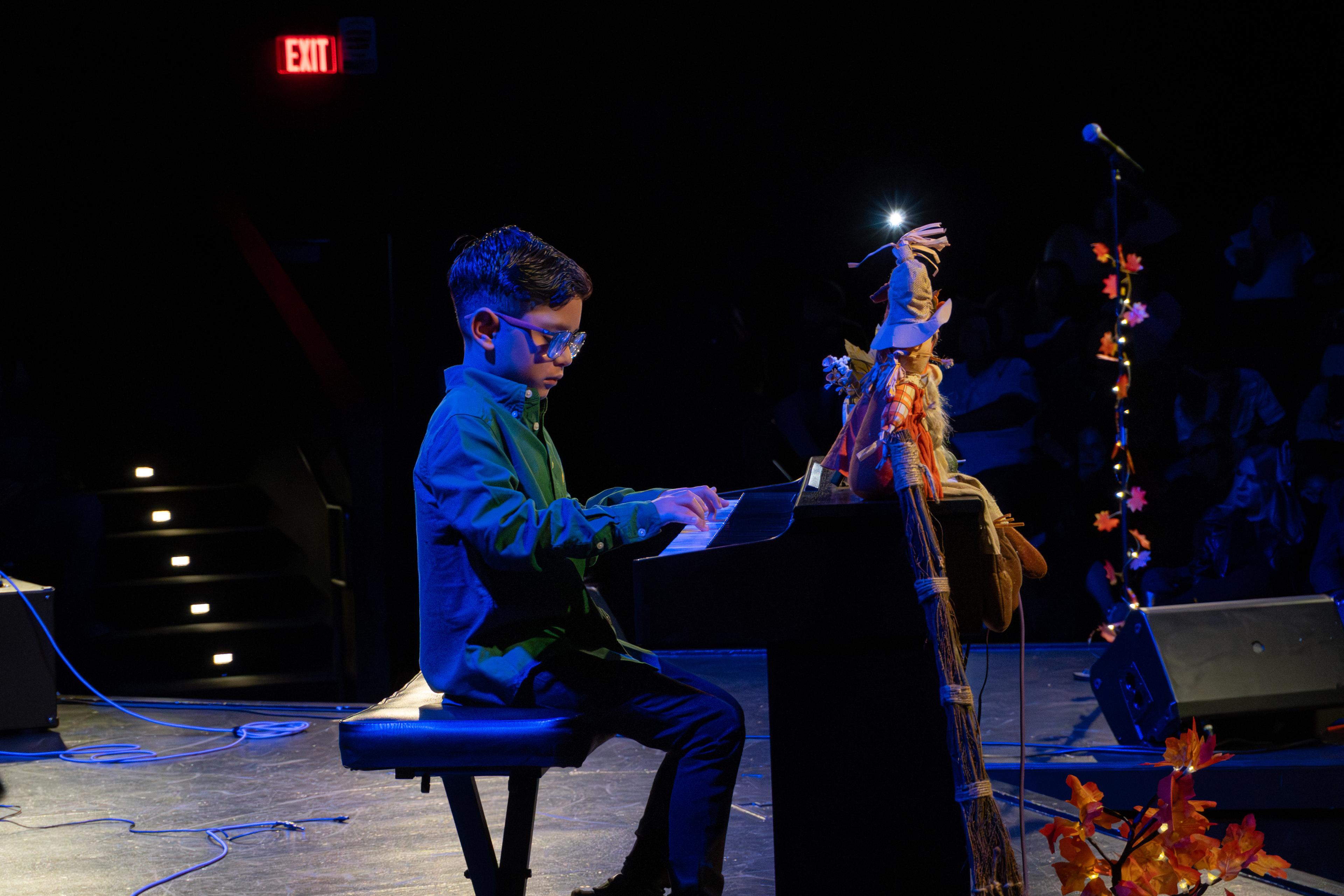 Young pianist performing at recital