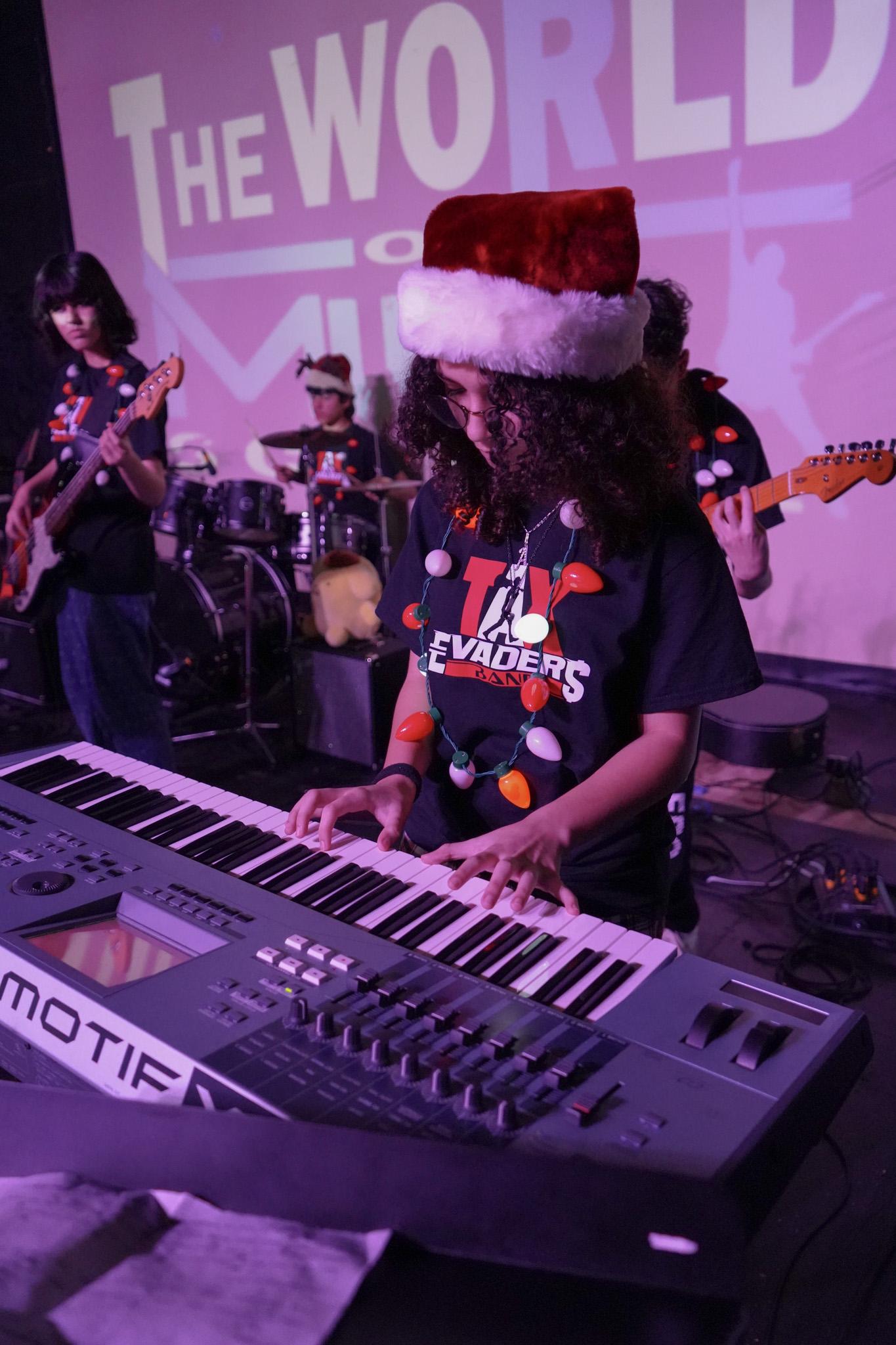 Student playing keyboard at Christmas themed concert