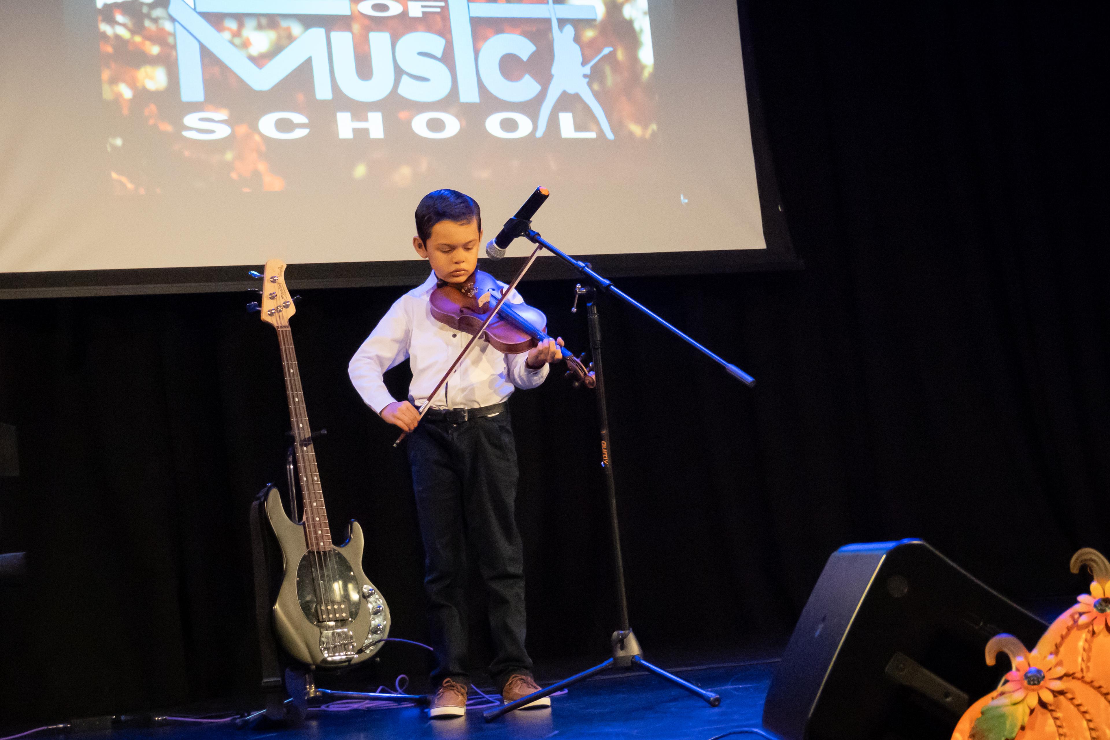 Young violinist performing at recital